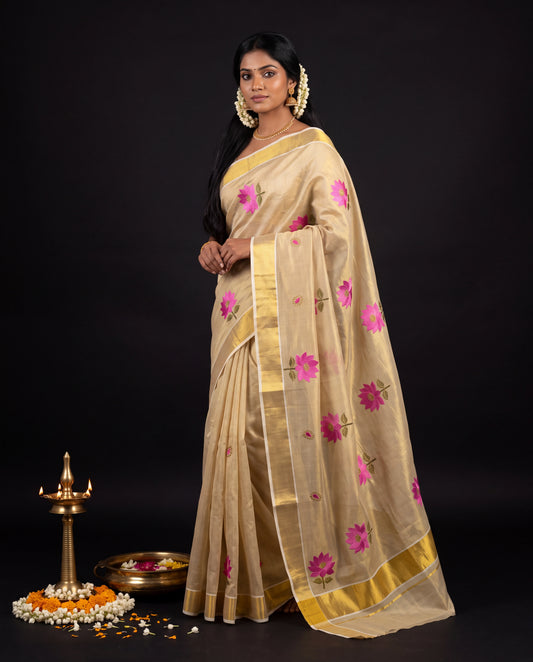 Cream Kerala tissue saree with pink lotus embroidery and gold zari border