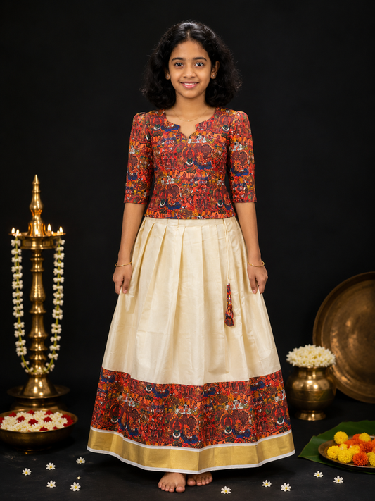Girl wearing traditional Kerala Pattupavada silk skirt and blouse with Kalamkari print