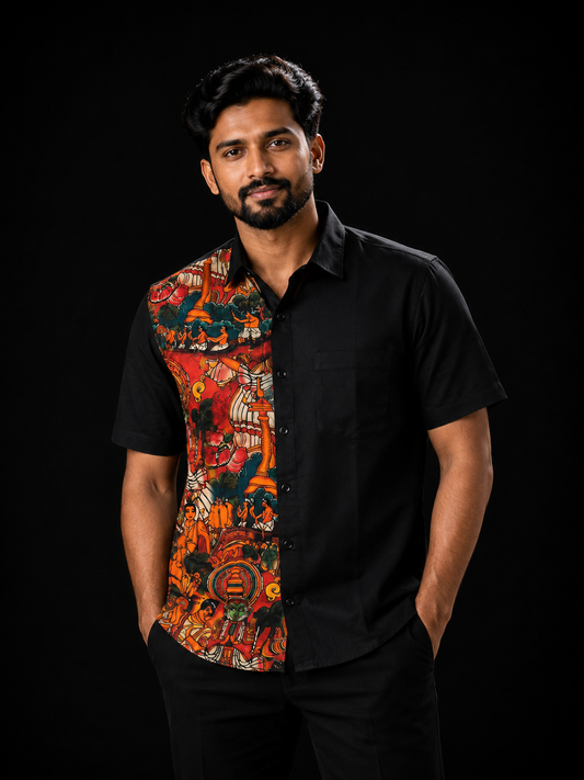 Man wearing a black short-sleeve shirt with a vibrant red and orange Kerala mural art panel on the left featuring temple scenes, classical dancers and mythological figures