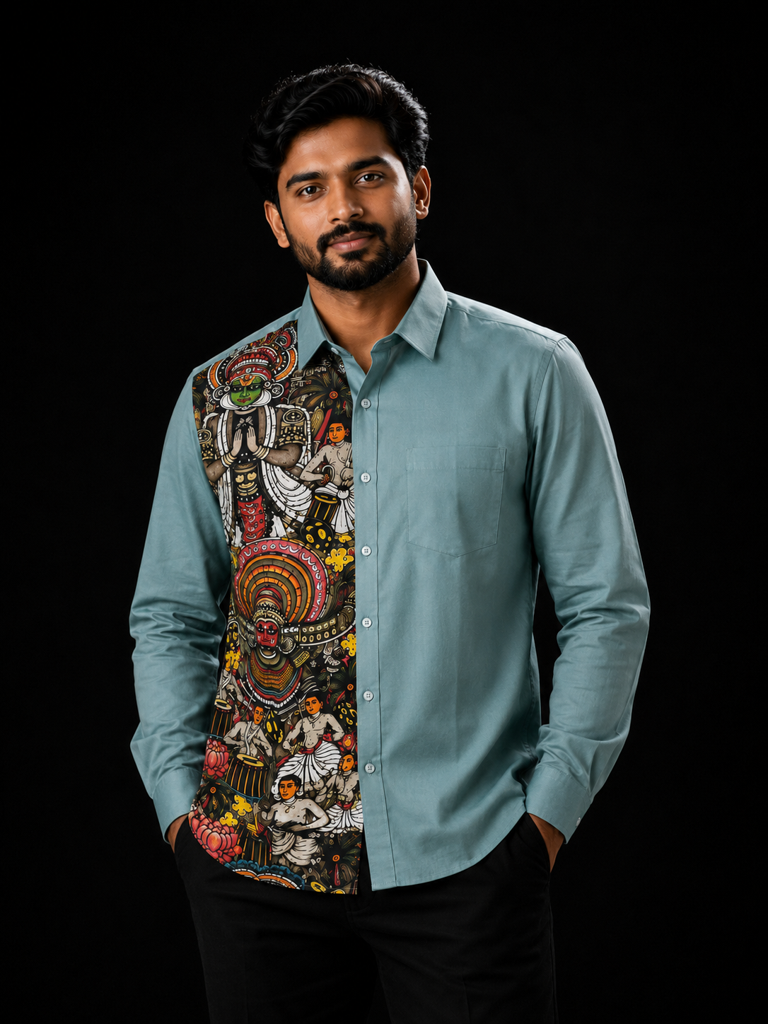 Man wearing a teal full-sleeve shirt with a Kerala art panel on the left featuring Kathakali, Theyyam deities, classical performers and floral motifs on a dark background
