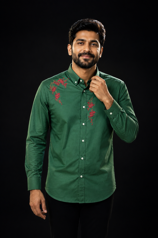 Man wearing a forest green full-sleeve shirt with red floral rose and vine embroidery on the chest